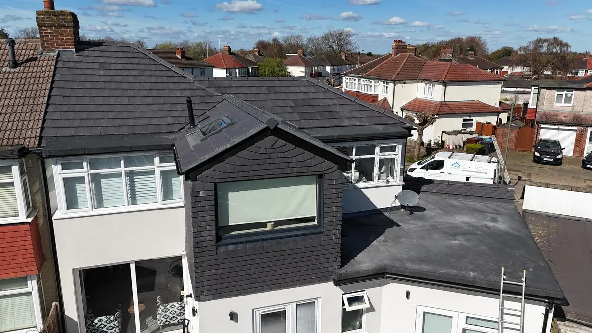 Completed slate dormer and re-roof with IKON Roofing van on site