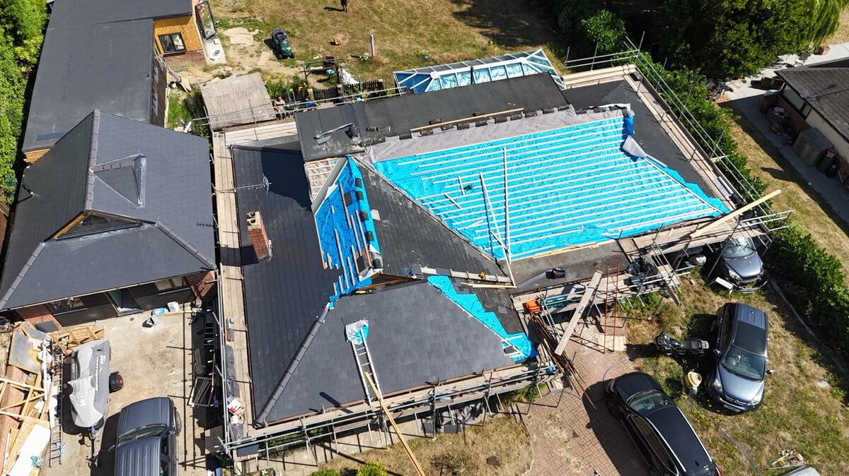 Aerial view of pitched re-roof in progress with scaffolding