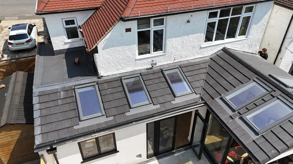 Drone view of slate roof with multiple Velux windows installed