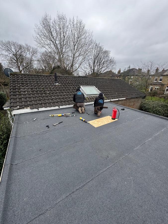 Torch-on flat roof installation in progress