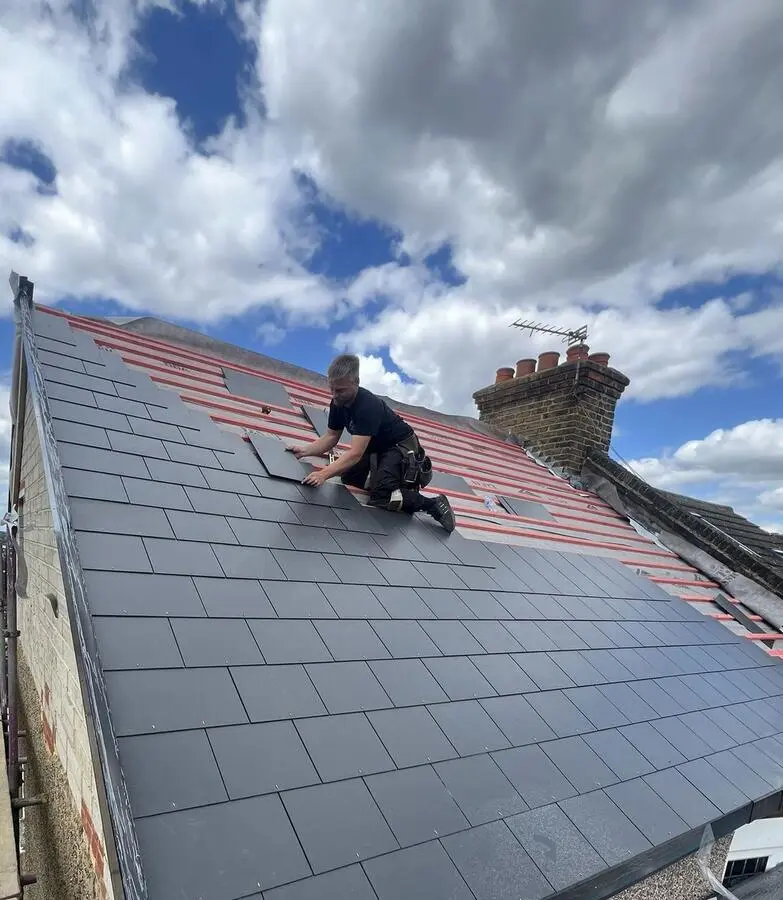 Jordan, owner of IKON Roofing, slating a roof in Kent