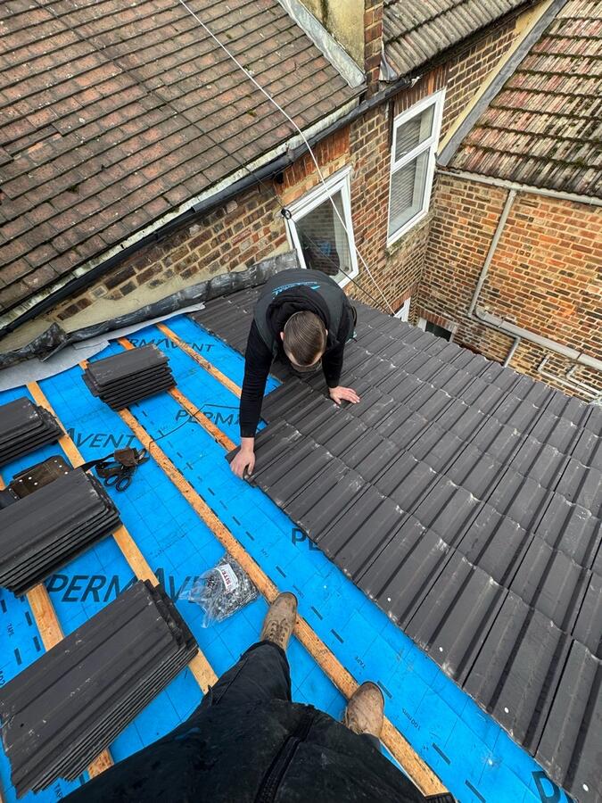 Concrete tiles being laid on membrane