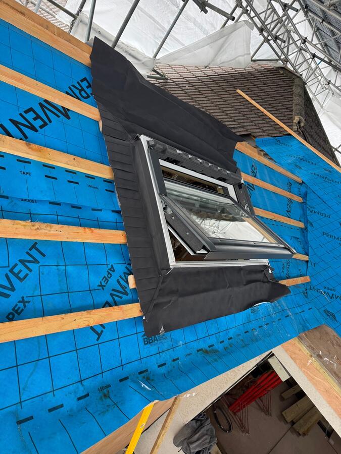 Completed flat roof with skylight and Ikon Roofing team