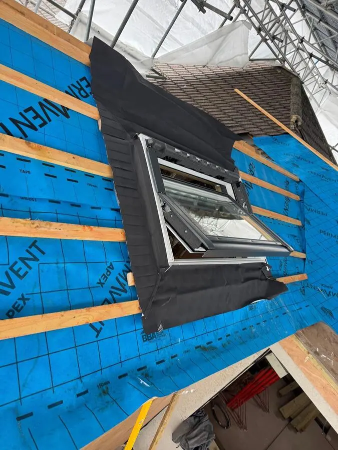 Completed flat roof with skylight and Ikon Roofing team