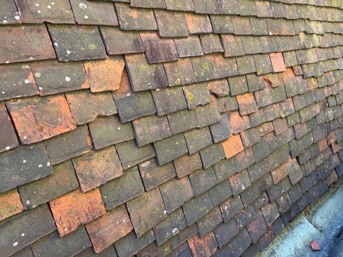 Worn and slipped tiles showing signs roof needs replacing